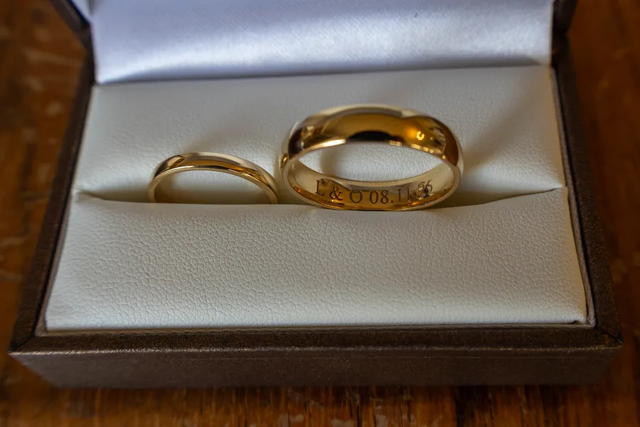 Engraved gold wedding rings in their box