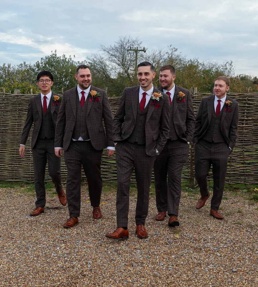 Groomsmen in checked tweed suits walking together