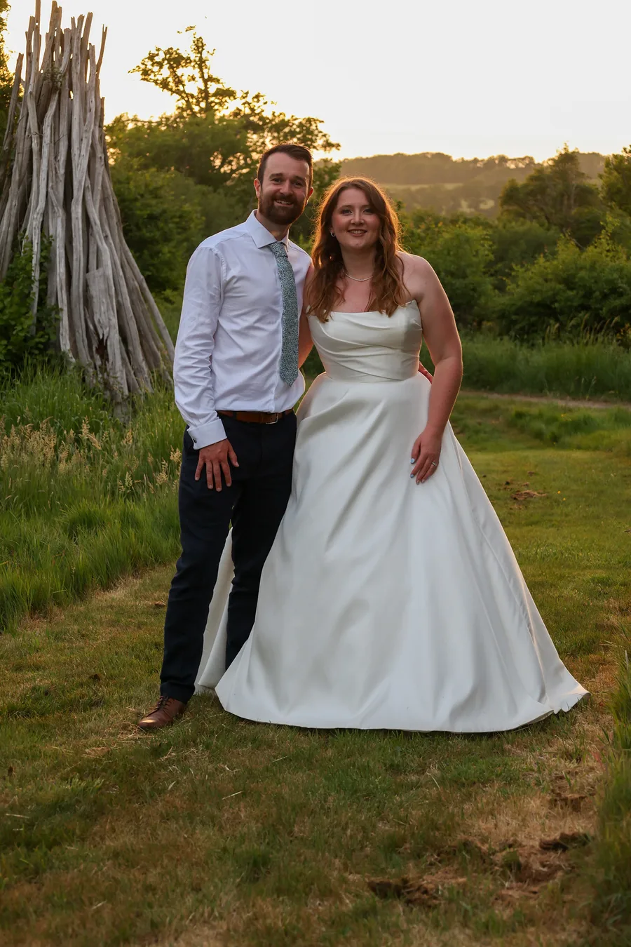 Bride and groom standing together in the evening light