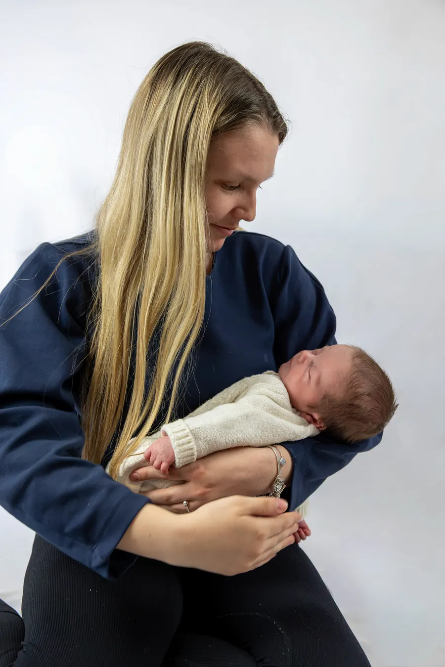 A woman holding her newborn baby on her lap