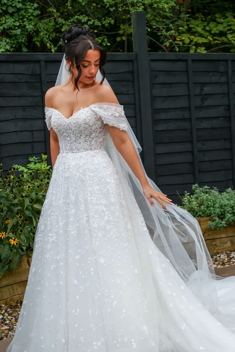 Bride looking back over her shoulder in the garden
