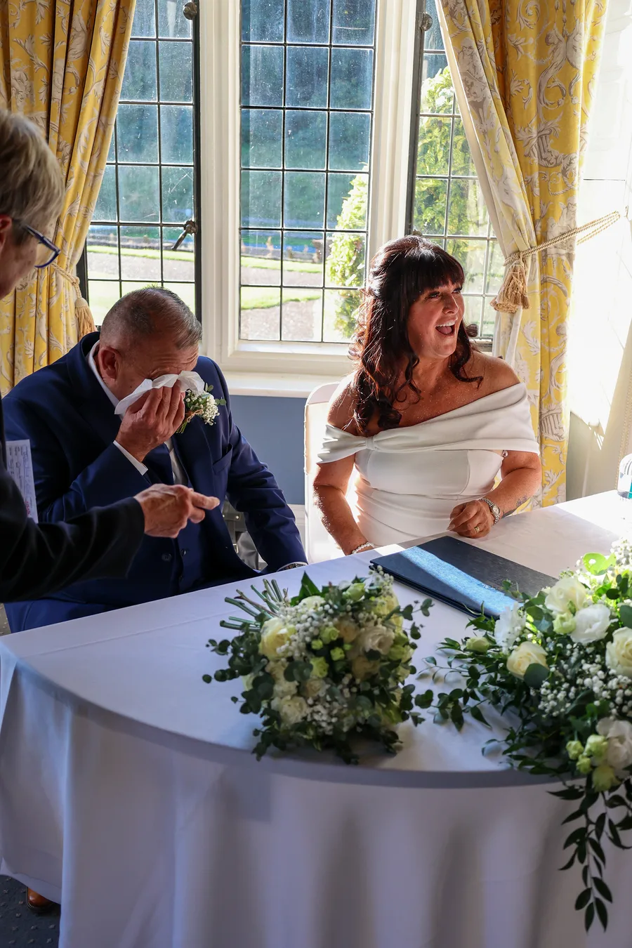 An unforgettable moment: The groom sheds tears of joy while signing the wedding certificate.